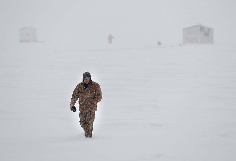 Icefisherman Ken Booth of Hollis is walking to his truck in near white-out conditions, but will return to his shack on Sebago Lake for an all-night fishing expedition during a massive blizzard on Friday, Feb.8, 2013. Storm3