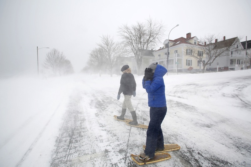 Lucy Sommo, right, of Portland braces herself from the strong winds along the Eastern Promenade while snowshoeing with Jean Geslin during a blizzard on Saturday morning in Portland on February 9, 2013.