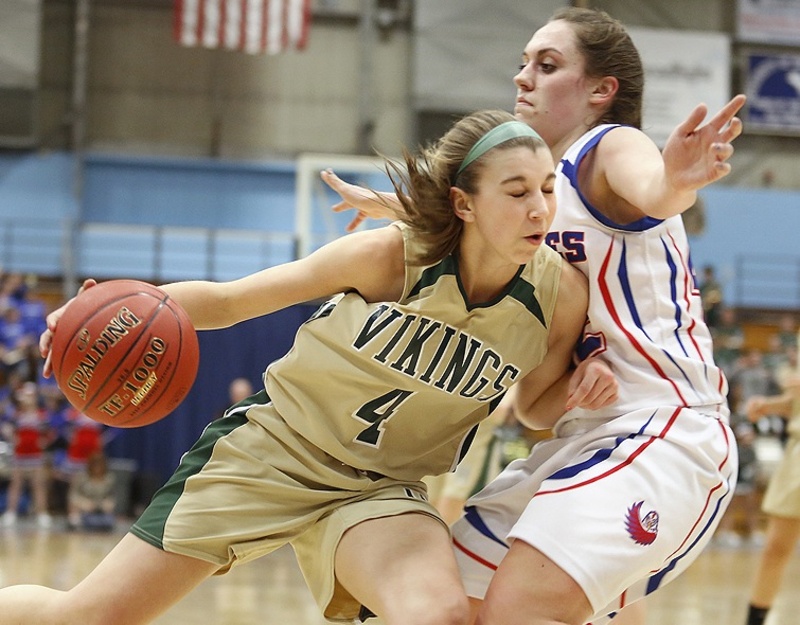 Mallory Nelson of Mt. Ararat stands her ground as Anna Winslow of Oxford Hills attempts to drive along the baseline during their quarterfinal at the Augusta Civic Center. Mt. Ararat and Bangor will meet Wednesday in one of the regional semifinals.