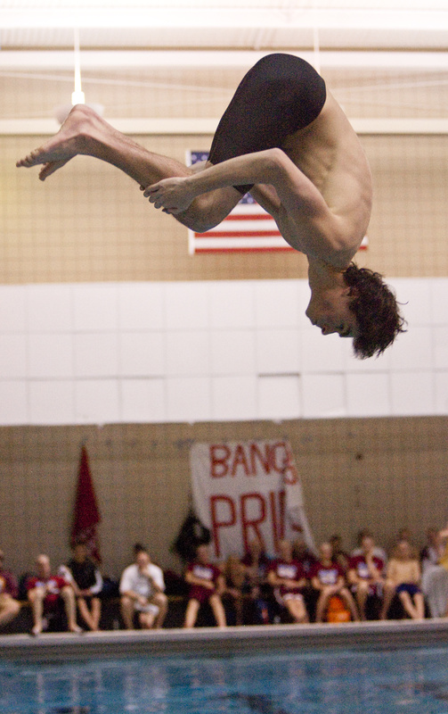 Michael Gordon, a Cheverus senior, performs a dive during the 1-meter competition at Bowdoin on Monday. Gordon earned a third place in the diving competition.