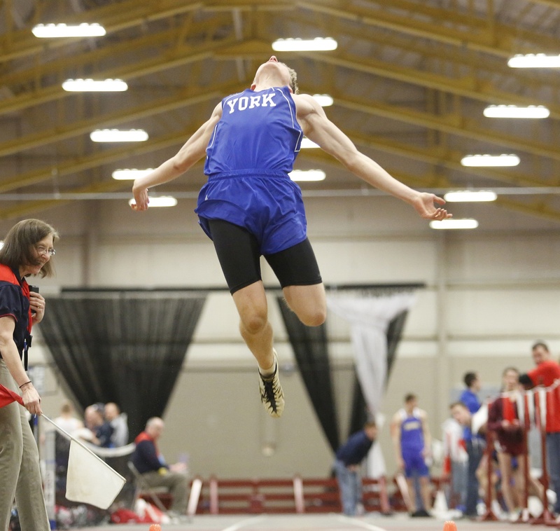 Derek Davis/Staff Photographer Joe Vogel of York soars into the pit while competing in the long jump Monday at the Class B indoor track championships in Lewiston. Vogel finished third, helping York to a second consecutive state championship.