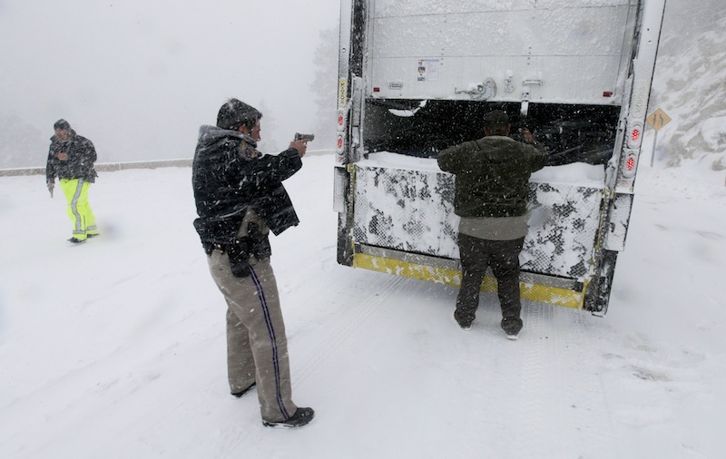 Members on the California Highway Patrol search a truck for Christopher Dorner, a former Los Angeles police officer accused of carrying out a killing spree because he felt he was unfairly fired from his job, Friday, Feb. 8, 2013, in Big Bear Lake, Calif. (AP Photo/Chris Carlson)