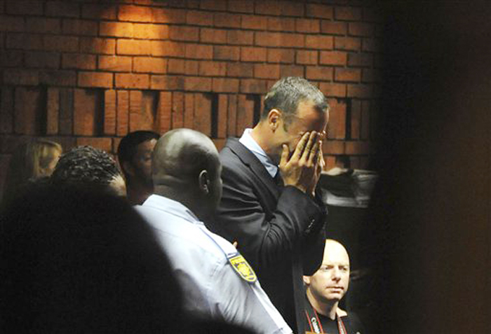 Oscar Pistorius weeps in court in Pretoria, South Africa, on Friday, Feb 15, 2013, at his bail hearing in the murder case of his girlfriend Reeva Steenkamp.