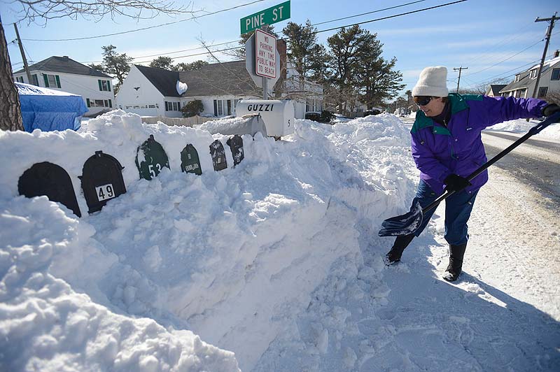 Pat Dunn of Pine Point shovels out mailboxes at the end of Pine Street in Pine Point on Sunday.