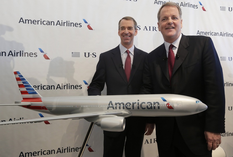 US Airways CEO Doug Parker, right, and American Airlines CEO Tom Horton pose at DFW International Airport on Thursday in Grapevine, Texas.