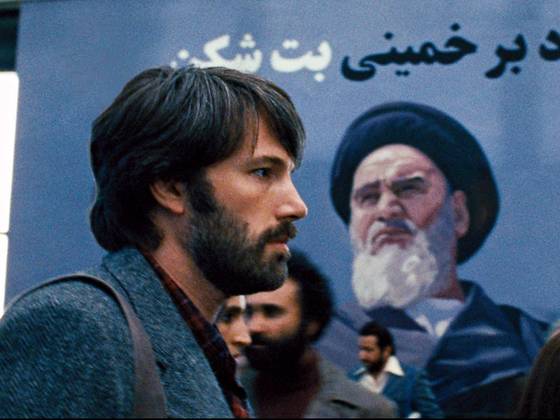 In this image from the Oscar-winning film 'Argo,' the protagonist Tony Mendez, portrayed by Ben Affleck, walks past a mural in Tehran, Iran depicting the Ayatollah.