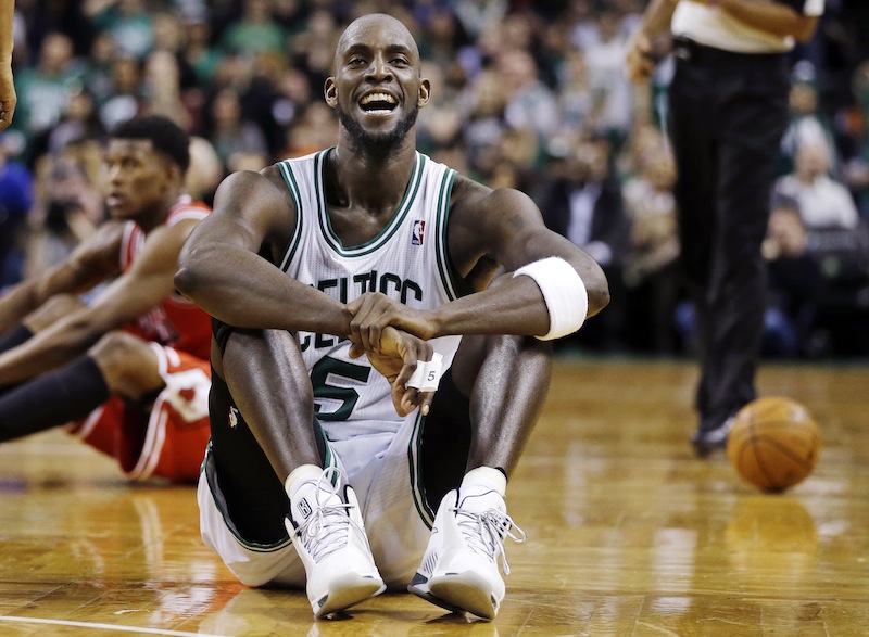 Boston Celtics forward Kevin Garnett (5) reacts on the court after a floor scramble with Chicago Bulls forward Jimmy Butler (21) during the fourth quarter of an NBA basketball game in Boston, Wednesday, Feb. 13, 2013. The Celtics gained possession of the ball and went on to win 71-69. (AP Photo/Elise Amendola)
