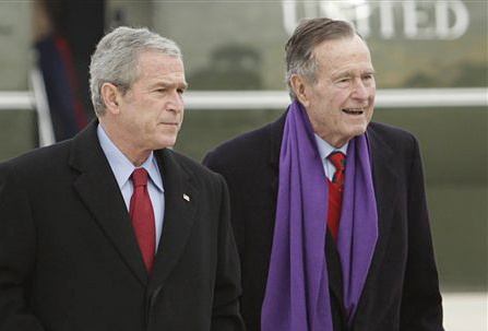 President George W. Bush walks with his father, former President George H.W. Bush in this 2008 photo. A criminal investigation is under way after a hacker apparently accessed private photos and emails sent between members of the Bush family, including both former presidents.