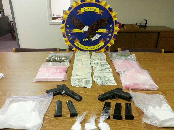 Police say they seized cocaine valued between $160,000 and $200,000, two handguns, $13,730 in cash, and 3/4 of a pound of marijuana.