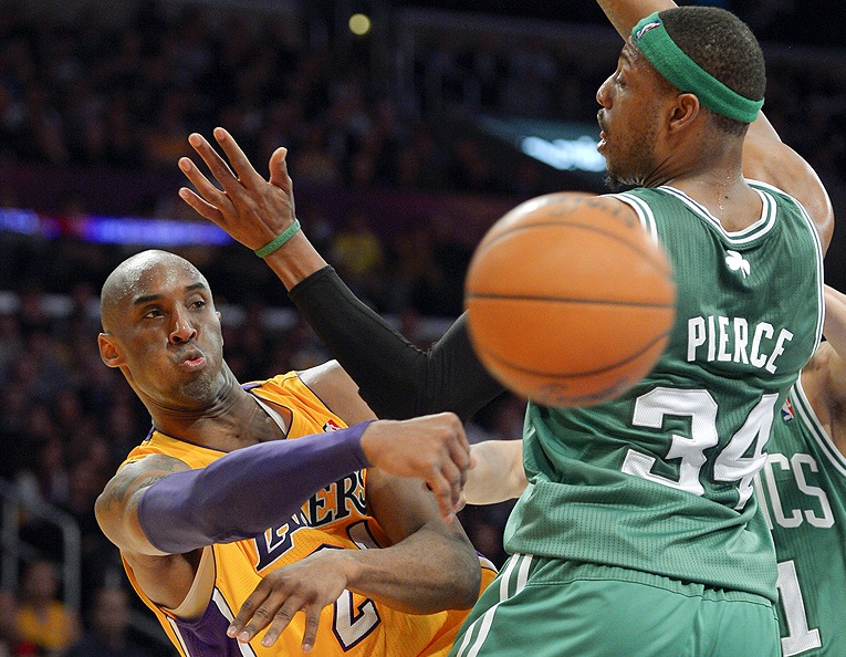 Lakers guard Kobe Bryant passes around Celtics forward Paul Pierce during the first half Wednesday in Los Angeles. The Lakers won, 113-99.