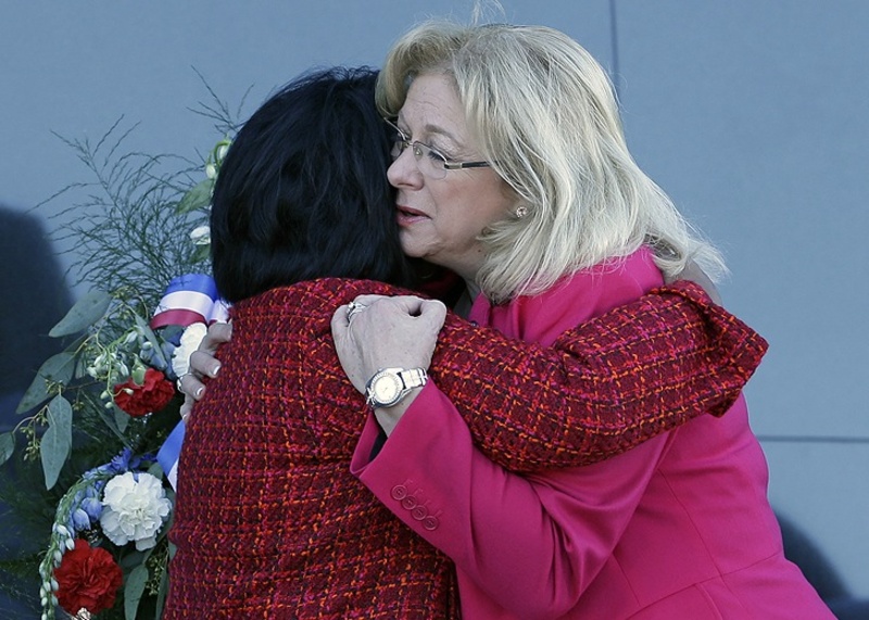 Space shuttle Columbia widows Sandra Anderson, left, and Evelyn Husband-Thompson embrace during a ceremony on the 10th anniversary of the disaster.