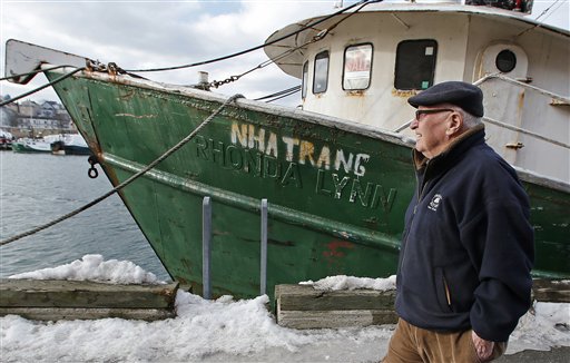 In this photo taken Wednesday, Feb. 13, 2013, Ron Gilson, a 79-year-old life Gloucester native, walks along the fish pier in Gloucester, Mass. Fishermen from all over New England have written to Congress asking for urgent help surviving deep cuts to their catch limits. (AP Photo/Charles Krupa)