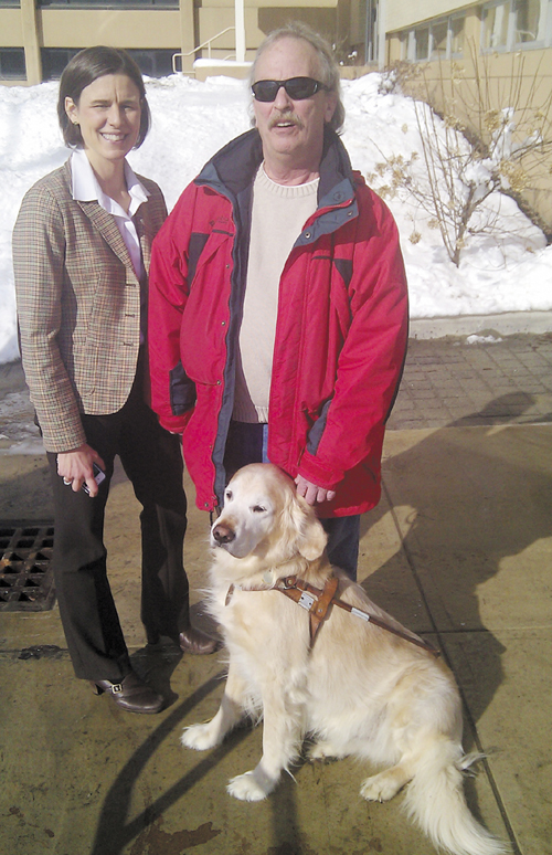 Bruce Archer of Presque Isle, right, his Seeing Eye dog Flash, and Kristin Aiello, an attorney with the Disability Rights Center who represented Archer in the discrimination complaint he filed with the Maine Human Rights Commission.