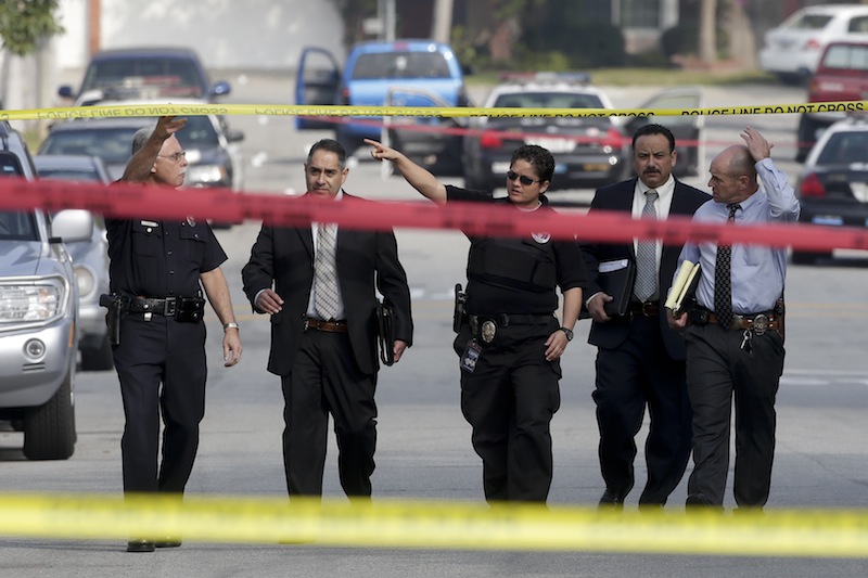 Law enforcement members look over the scene of an shooting linked to ex-cop Christopher Dorner in Torrance, Calif., on Feb. 7. The death of the ex-Los Angeles police officer in a fiery standoff with authorities has done little to quell online chatter over a man whose rampage against law enforcement created a small but vocal following.