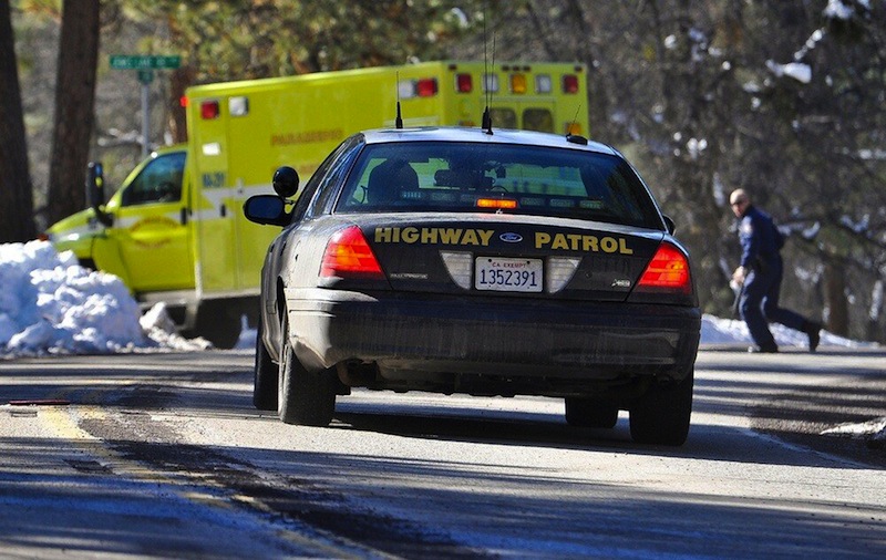 Law enforcement officials respond after Christopher Dorner, the fugitive ex-Los Angeles cop sought in three killings, engaged in a shootout with authorities that wounded two officers in the San Bernardino Mountains near Big Bear Lake, Calif., Tuesday, Feb. 12, 2013. (AP Photo/The Sun, Rachel Luna) MANDATORY CREDIT