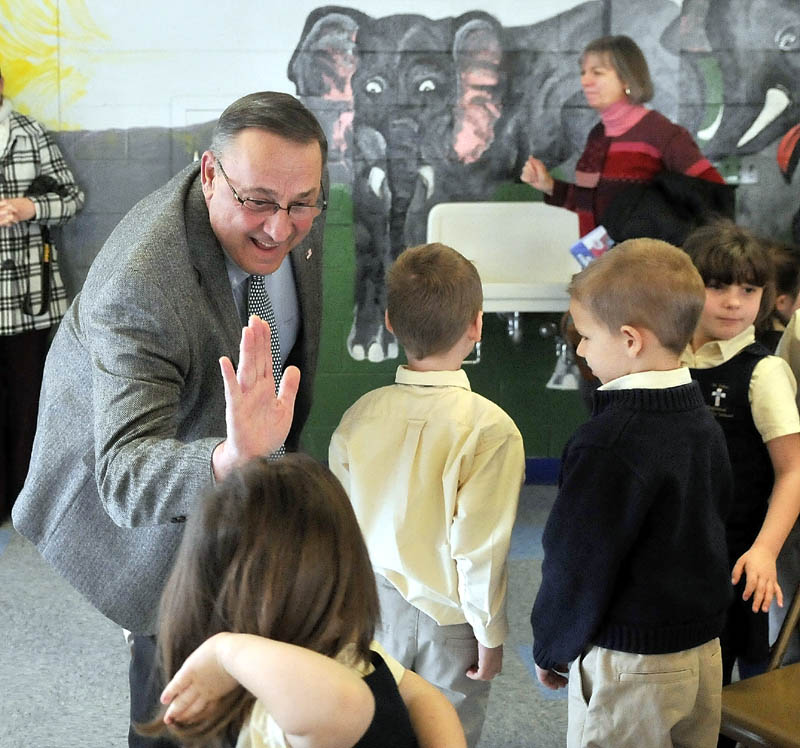 Gov. Paul LePage greets students after reading to the student body at St. John Regional Catholic School in Winslow on Friday.