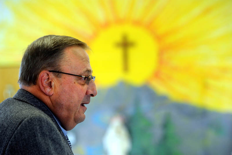 Gov. Paul LePage reads to the student body as part of the 2013 Catholic Schools Week celebration at St. John Regional Catholic School on 15 South Garand Street in Winslow on Friday morning.