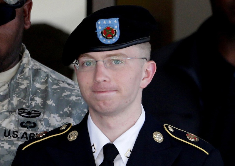 In this June 25, 2012 file photo, Army Pfc. Bradley Manning, right, is escorted out of a courthouse in Fort Meade, Md. The Army private charged in the largest leak of classified material in U.S. history says he sent the material to WikiLeaks to enlighten the public about American foreign and military policy on Thursday, Feb. 28, 2013. (AP Photo/Patrick Semansky, File)