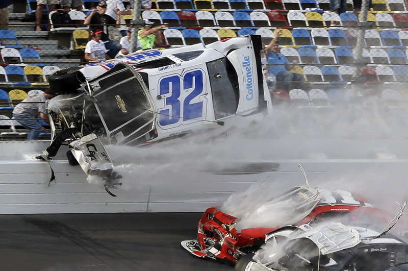 Kyle Larson goes airborne and into the catch fence during a multicar crash involving Justin Allgaier, 31, Brian Scott, 2, and others during the final lap of the NASCAR Nationwide Series auto race at Daytona International Speedwayon Saturday.