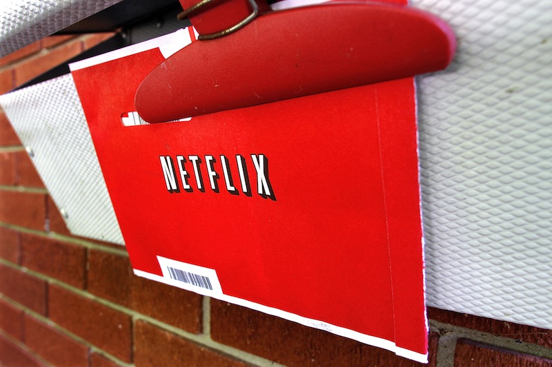In this Thursday, Aug. 23, 2012, file photo, a Netflix envelop containing a DVD to be returned by mail is clipped onto a mailbox, in Springfield, Ill. Netflix won’t miss Saturday mail delivery, even though the weekend service helped keep its DVD-by-mail subscribers happy. The U.S. Postal Service’s planned shift to five days of home delivery a week instead of six may even make Netflix Inc. slightly more profitable. (AP Photo/Seth Perlman)