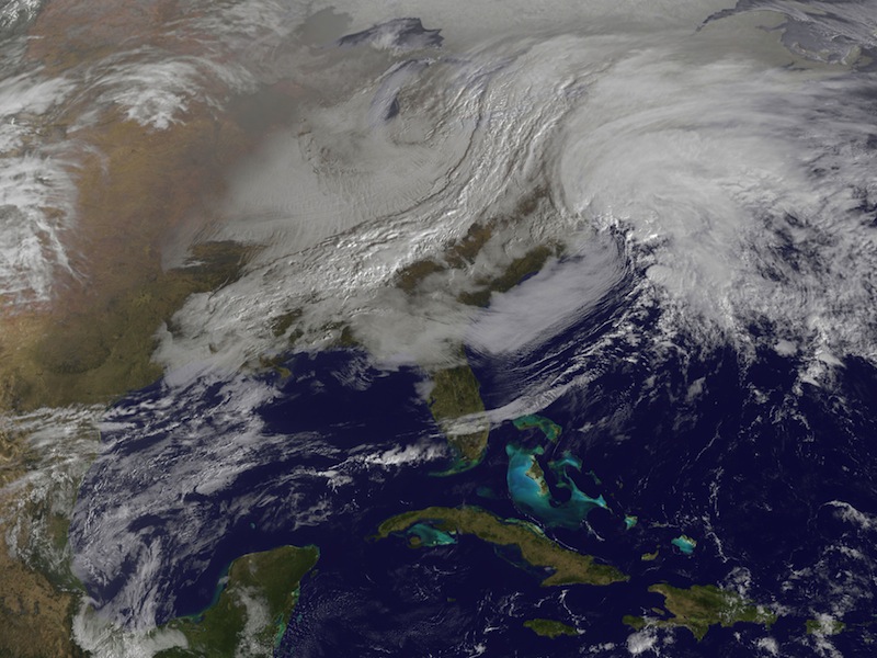 This image released by NASA from NOAA's GOES-13 satellite captured at 9:01 a.m. on Friday, Feb. 8, 2013 shows a massive winter storm coming together as two low pressure systems merge over the northeast U.S. Snow began falling across the Northeast on Friday, ushering in what was predicted to be a huge, possibly historic blizzard and sending residents scurrying to stock up on food and gas up their cars. (AP Photo/NASA)