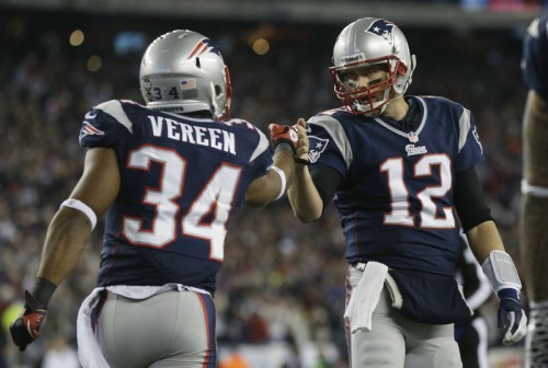 New England Patriots running back Shane Vereen, left, is congratulated by quarterback Tom Brady after Vareen's eight-yard touchdown pass reception from Brady in the AFC divisional playoff game Jan. 13. Tom Brady has signed a 3-year extension with the Patriots.
