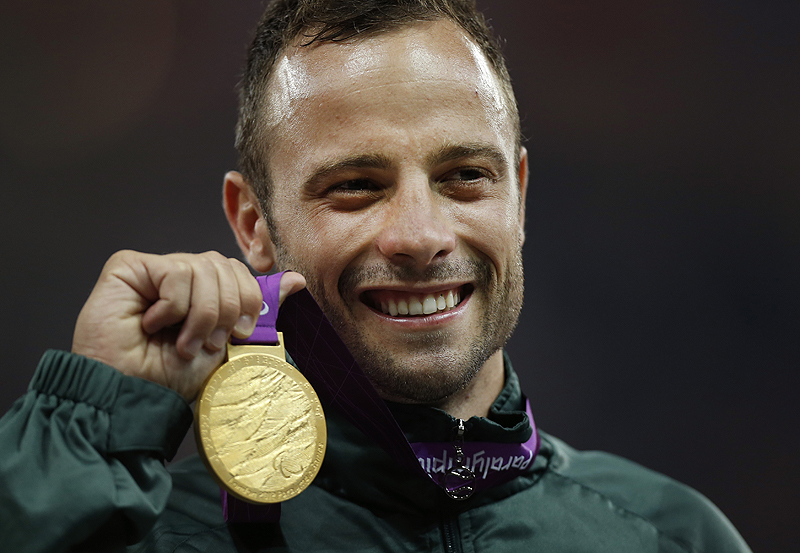 South Africa's Oscar Pistorius poses with his gold medal after winning the men's 400 meters T44 category final at the 2012 Paralympics, in London. Pistorius was arrested in the killing of Reeva Steenkamp, who was shot on Valentine's Day.