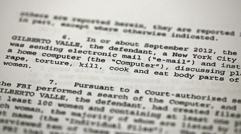 This Oct. 25, 2012 file photo shows a passage of a Federal complaint filed in New York, against New York City Police Department officer Gilberto Valle. Valle is accused of kidnapping conspiracy and admits to thinking about abducting, cooking and devouring young women. His own lawyer has shown prospective jurors a kinky staged photo of a woman trussed up in a roasting pan to test their tolerance for the officer’s "weird proclivities." (AP Photo/Richard Drew, File)