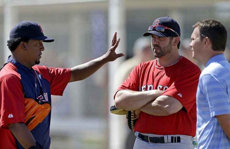 Former Boston Red Sox pitcher Pedro Martinez, left, and former catcher and captain, Jason Varitek, center, both now special assistants to the team, speak with general manager Ben Cherington, right, during a spring training baseball workout, Wednesday, Feb. 20, 2013, in Fort Myers, Fla. (AP Photo/David Goldman)