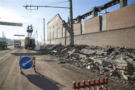 Municipal workers repair a damaged power circuit outside a zinc factory where a section of the roof collapsed when a meteorite exploded over the Chelyabinsk region on Friday.