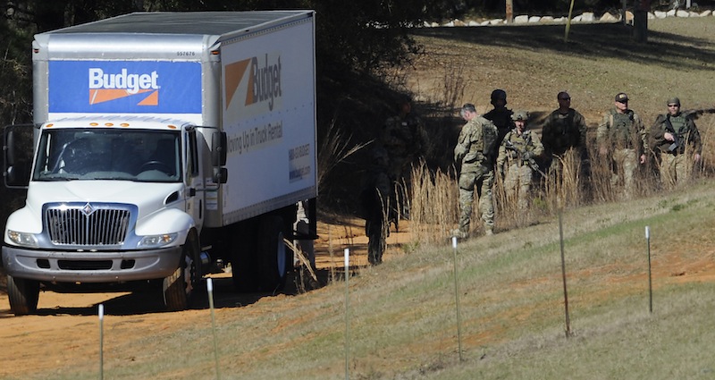 Authorities gather at the Dale County hostage scene in Midland City, Ala. on Thursday morning, Jan. 31, 2013. A gunman holed up in a bunker with a young hostage has kept law officers at bay since the standoff began when he killed a school bus driver and dragged the boy away, authorities said. (AP Photo/Montgomery Advertiser, Mickey Welsh)