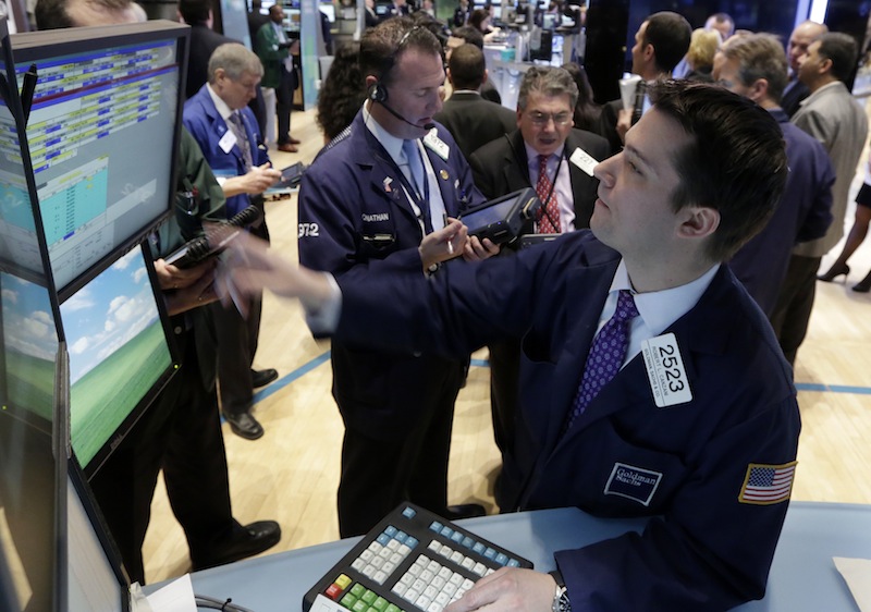 Specialist Robert Canzani, right, works at his post on the floor of the New York Stock Exchange Monday, Feb. 25, 2013. (AP Photo/Richard Drew)