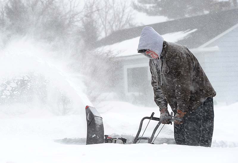 Charles Harris clears snow from his drive in Gorham on Saturday.