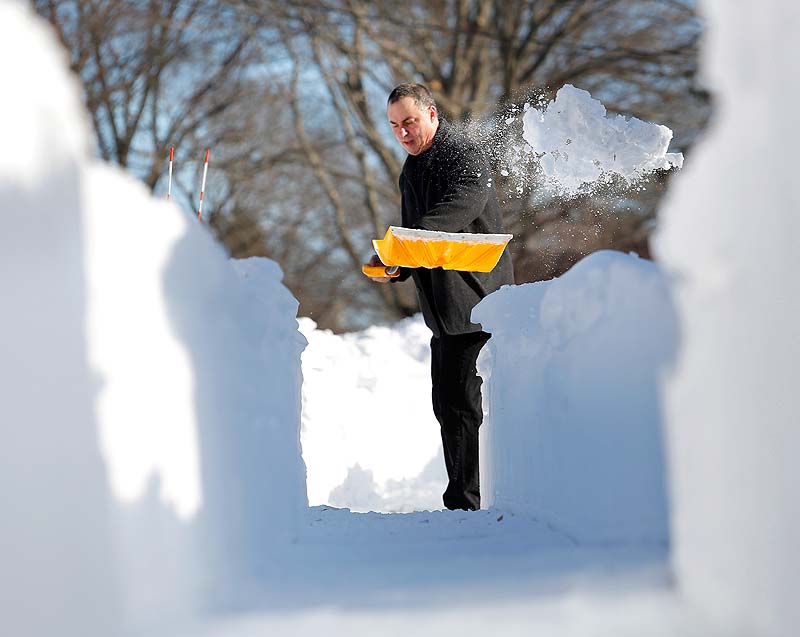 Jerry Hunter shovels his walkway in Portland on Sunday after a weekend storm brought 31.9 inches of snow to the city.