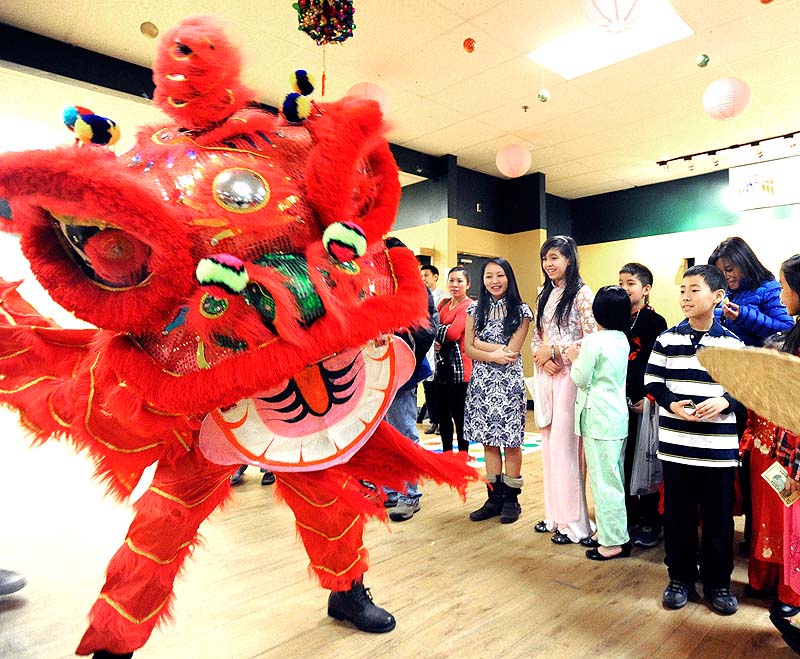 Children enjoy the dragon dance during the celebration of the Lunar New Year by the Vietnamese American Association of Maine at The Gold Room & Turf's in Portland on Saturday.