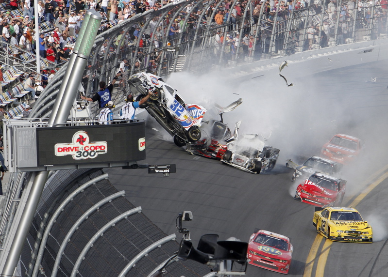 Kyle Larson's car goes airborne during a multicar wreck on the final lap of the NASCAR Nationwide Series race Saturday at Daytona International Speedway. Tony Stewart, front, avoided the crash and won the race.