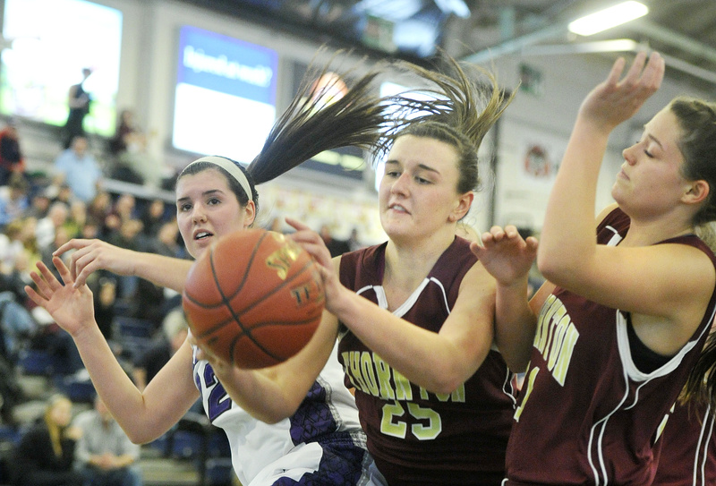 Olivia Shaw of Thornton Academy gains inside position Monday to haul down a rebound in front of Chelsea Saucier of Deering at the Expo.