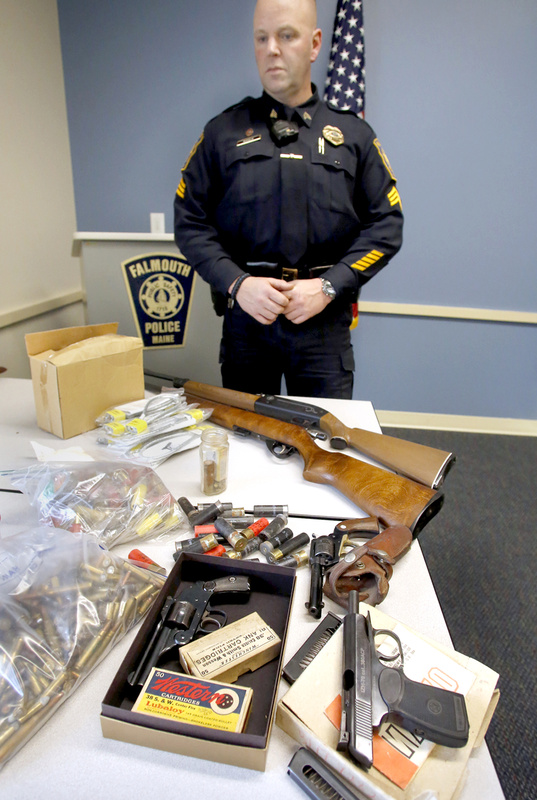 Falmouth Police Sgt. Frank Soule with guns and ammunition donated Saturday. Sales of some of them will benefit Special Olympics Maine.