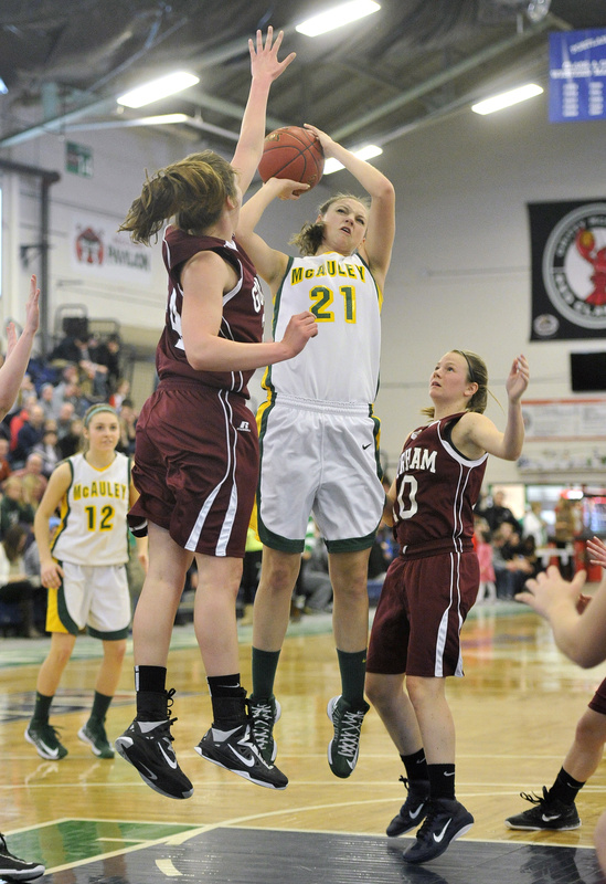 Olivia Smith tries to get a shot past the outstretched arm of Gorham’s Kristin Ross during top-ranked McAuley’s46-31 victory Monday night in a Western Class A quarterfinal at the Portland Expo.