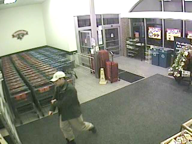 This surveillance image shows a man police believe was an accomplice who helped surveil the store before the burglary.