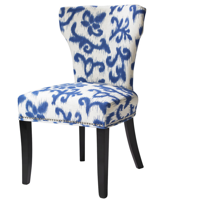 An upholstered chair in a blue and white print, also from HomeGoods.