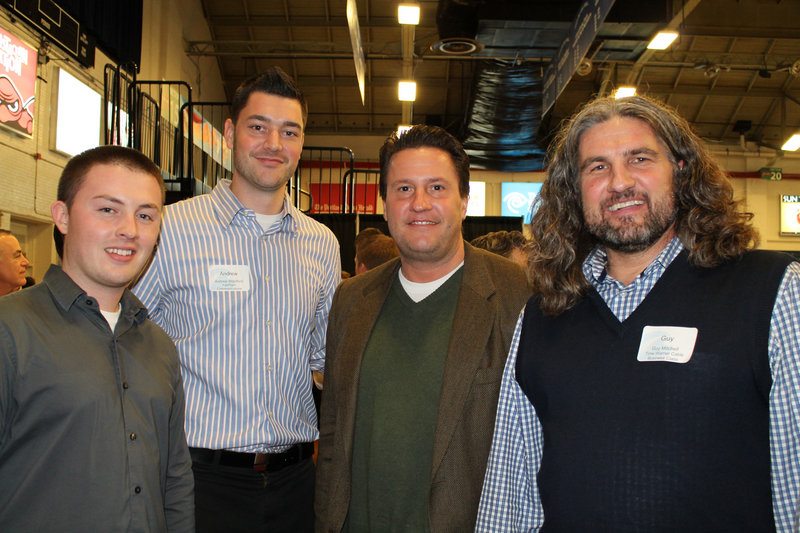Fairpoint Communications’ Adam Roy, Andrew “D.J. Drew” Woodford and Scott Dimick join Guy Mitchell of Time Warner Business Class in a bit of revelry courtside at the Portland Expo Wednesday night.