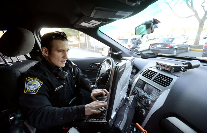 South Portland Police Officer Kevin Sager enters vehicle information into his computer to issue a ticket for an illegally parked car at the Maine Mall on Thursday, Jan. 31, 2013.