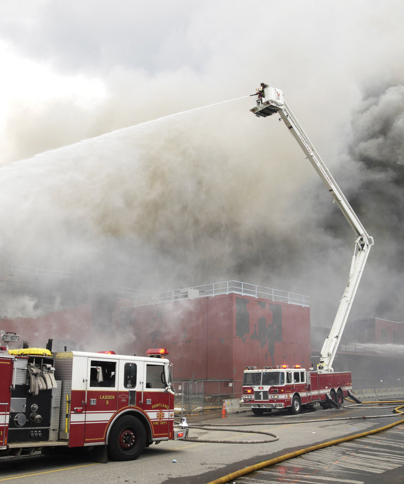 Portland personnel fight a blaze at the Jordan’s Meats plant on Middle Street in 2010. The lives of firefighters and community members are threatened because the city fire department isn’t able to staff fire trucks at levels established under the national fire safety code, a reader says.