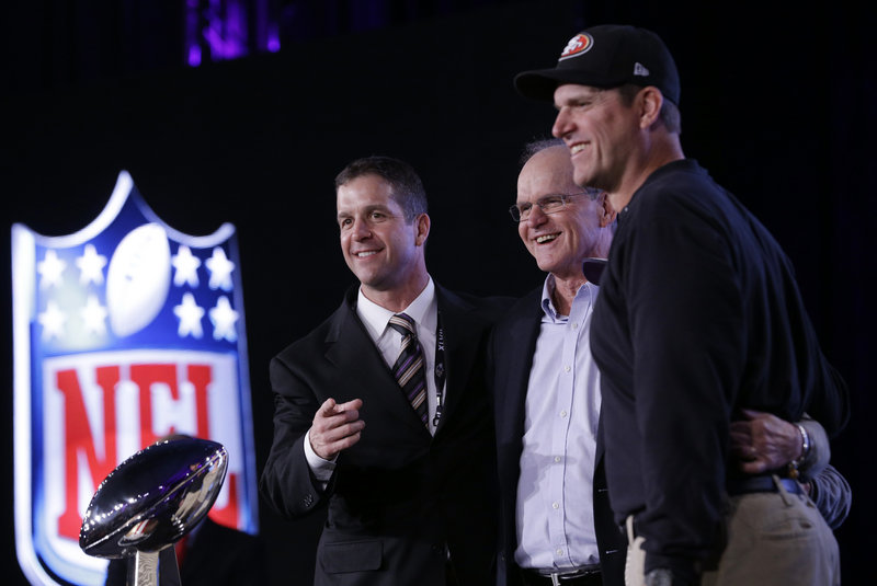 Baltimore Coach John Harbaugh, left, and San Francisco Coach Jim Harbaugh, right, pose with their father, former college coach Jack Harbaugh, during a news conference in New Orleans Friday.