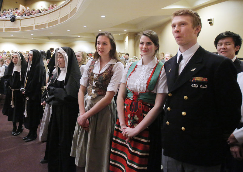 From right, Dainius Bukauskas, Grace Gilbert and Adela McVicar, all students at North Yarmouth Academy, wait to parade on stage at the start of the Sing-A-Long-A Sound of Music at Merrill Auditorium on Friday, February 1, 2013.
