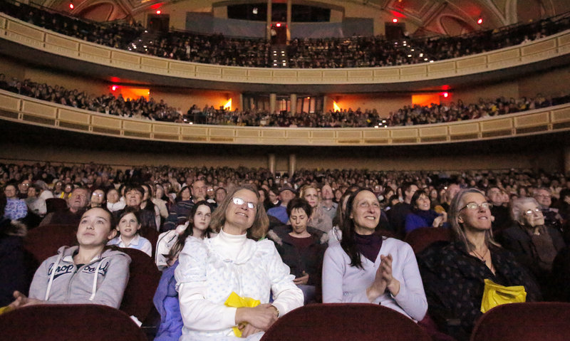 Sandi Radis, second from left and Robin Walden, both of Peaks Island, watch the opening scene of the film The Sound of Music during the Sing-A-Long-A Sound of Music at Merrill Auditorium on Friday, February 1, 2013.