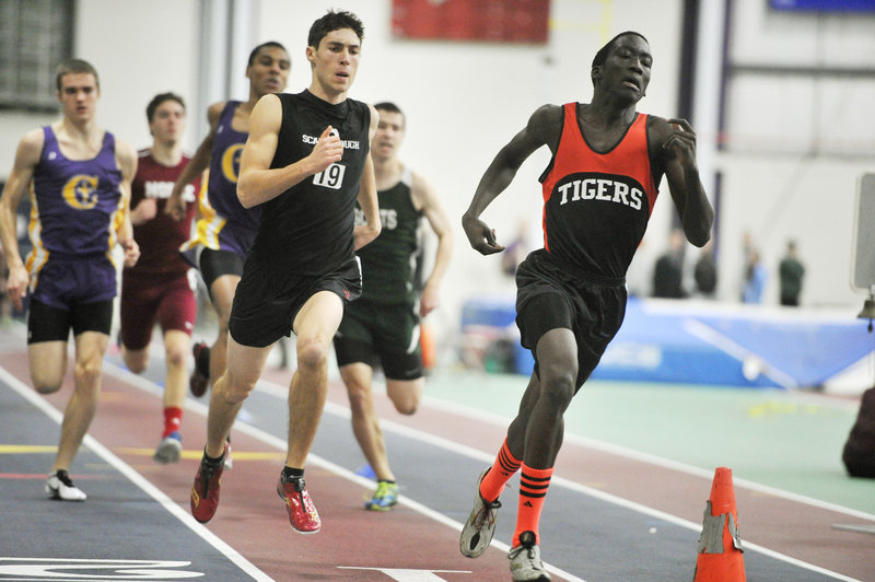 James Ociti, right, of Biddeford leads Greg Viola of Scarborough by a step midway through the 400. Ociti won the event by 1.22 seconds over Viola.
