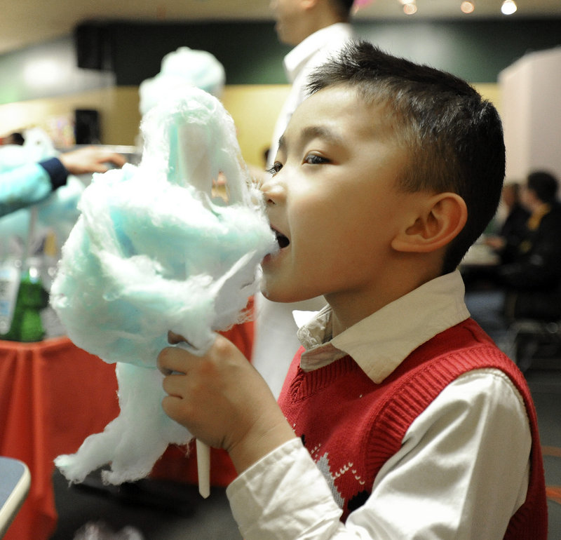 Ayden Tran, 5, enjoys cotton candy while celebrating the Vietnamese lunar new year in Portland on Saturday.