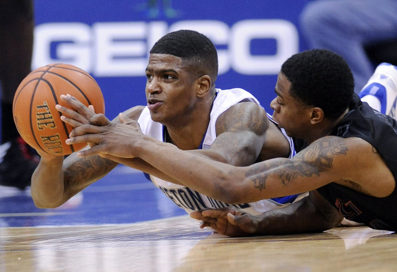 Seton Hall’s Aaron Crosby, left, looks to pass the ball as he is pressured by Cincinnati’s Ge’Lawn Guyn during first-half action of Saturday’s NCAA basketball game in Newark, N.J., won by the Bearcats 65-59.
